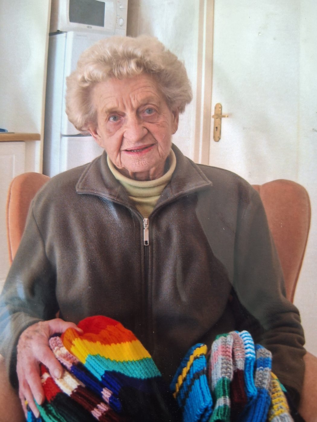 A gogo with a stack of hand-knitted beanies