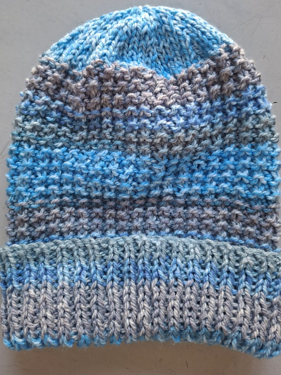 Blue, grey and teal marled beanie with a textured knit, hand-knitted at Kranshoek