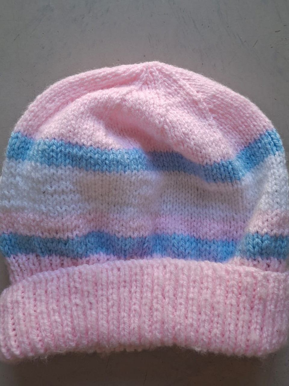 Pink beanie with pale blue stripes, hand-knitted at Kranshoek
