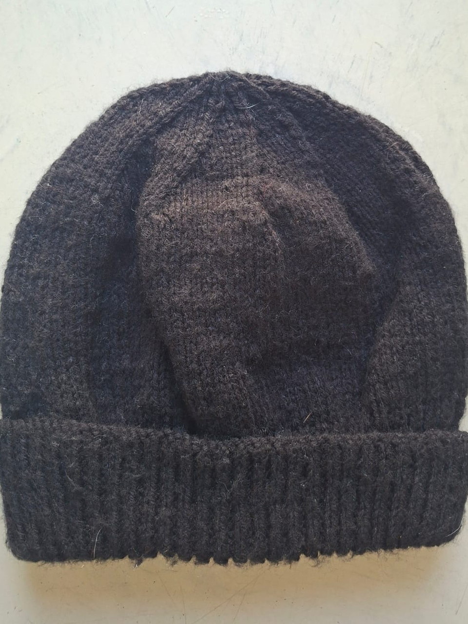 Solid dark coffee brown beanie, hand-knitted at Kranshoek