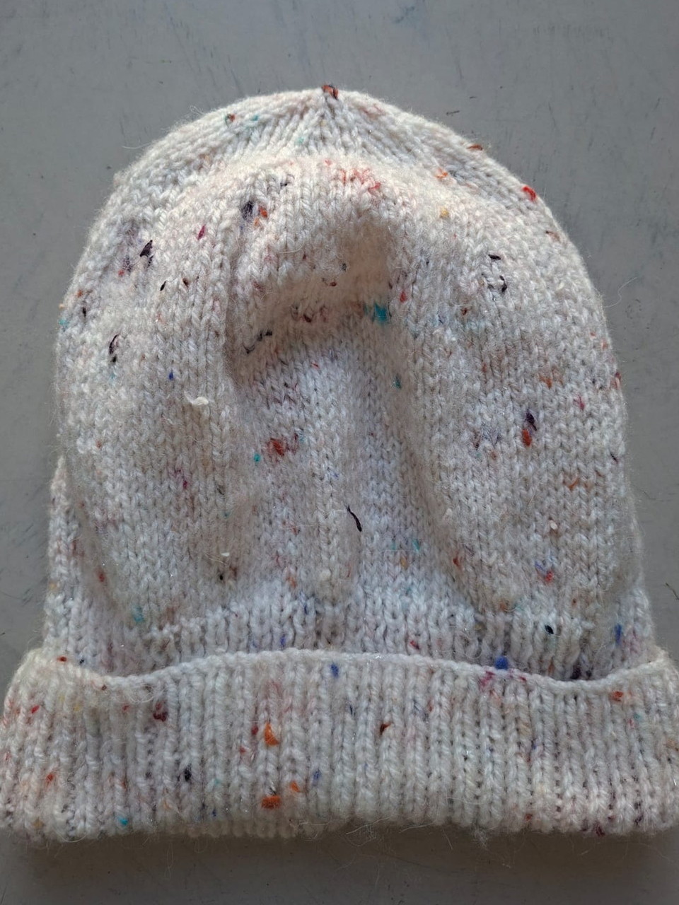 Cream flecked beanie with confetti specks, hand-knitted at Kranshoek
