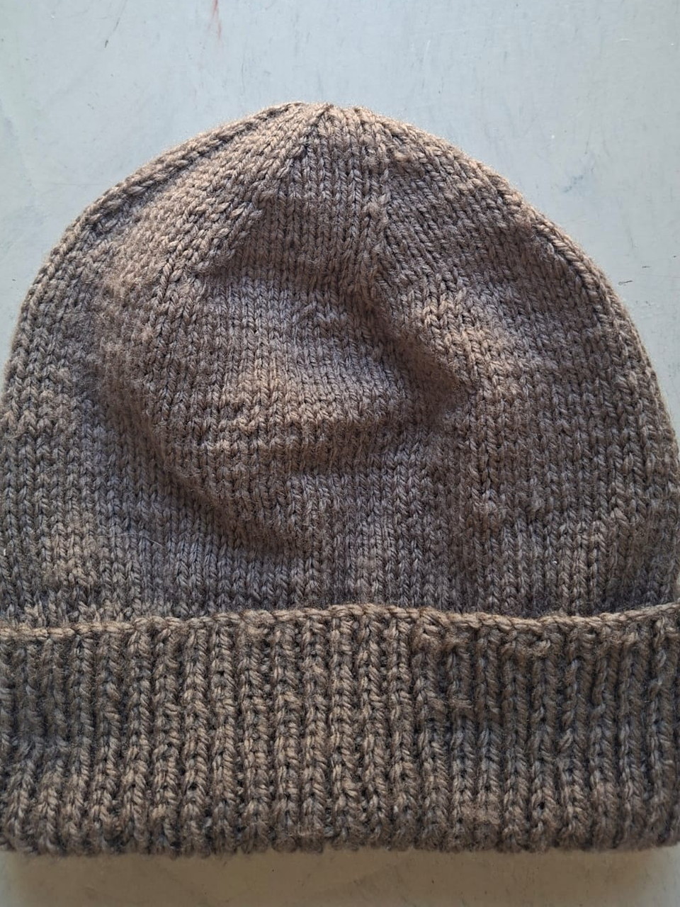 Solid taupe brown beanie with a folded rib cuff, hand-knitted at Kranshoek